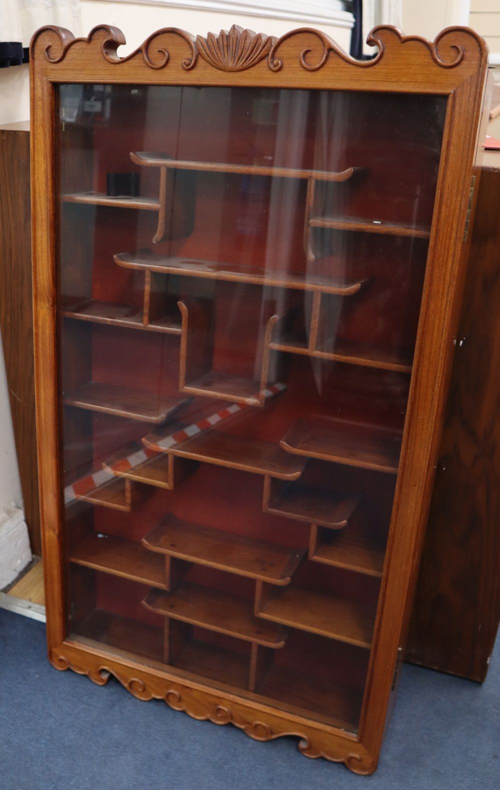 A Chinese glazed hardwood hanging cabinet, width 50cm, depth 11cm, height 88cm